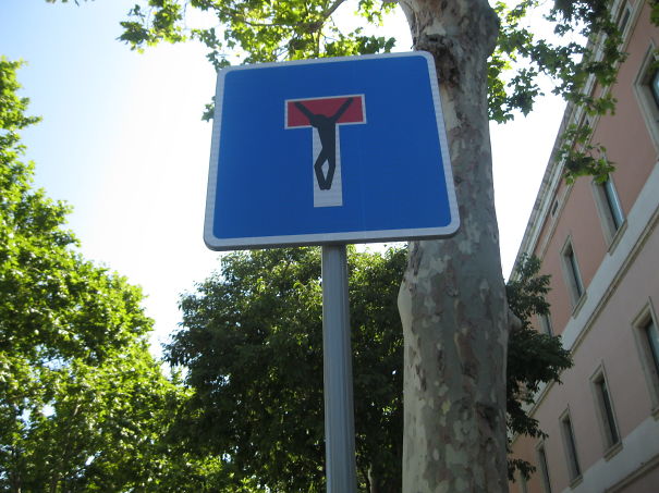 Street Sign Art By Abraham Clet - Barcelona Street Sign Art By Abraham Clet - Barcelona