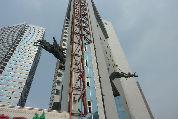 Shenzhen, China - Statue Inserted Into A Skyscraper