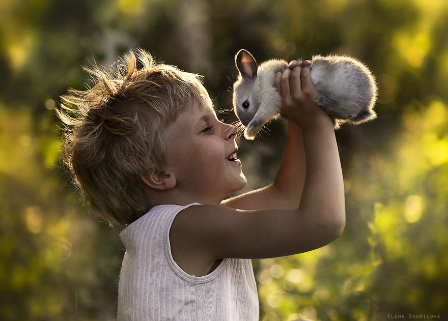 Child joyfully holding a rabbit against a farm backdrop, capturing a magical moment with Russian flair. Child joyfully holding a rabbit against a farm backdrop, capturing a magical moment with Russian flair.