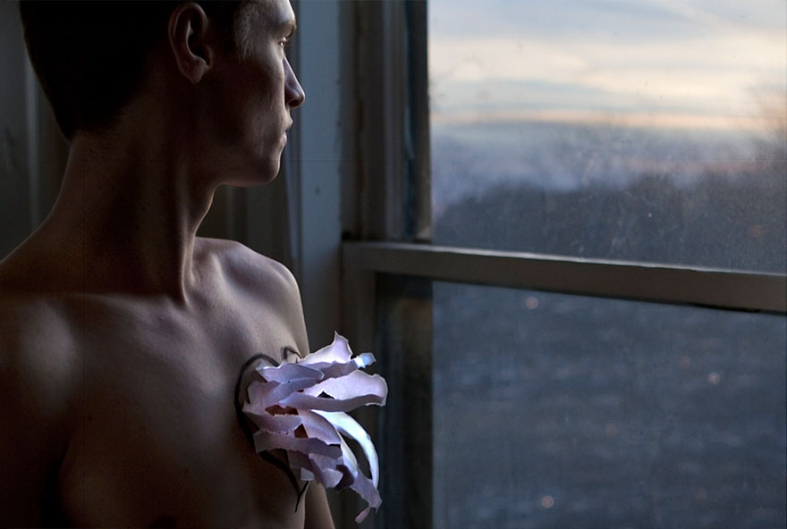 man with a painted heart on his chest from which the paper is sticking up man with a painted heart on his chest from which the paper is sticking up