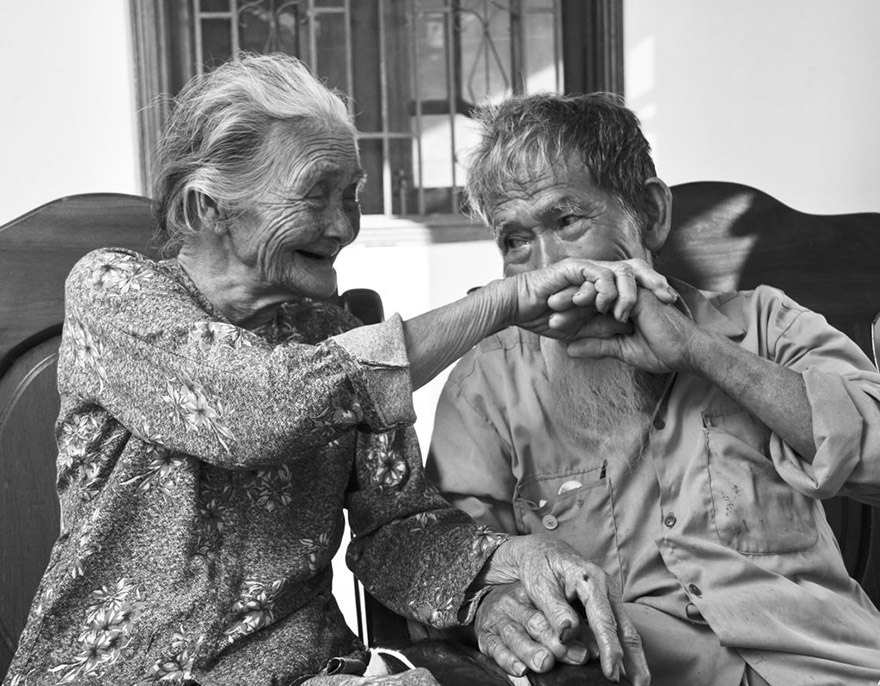 old man and woman holding their hands old man and woman holding their hands