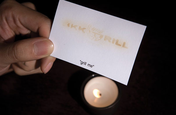 Creative business card with heat-sensitive reveal, held above a candle. Creative business card with heat-sensitive reveal, held above a candle.
