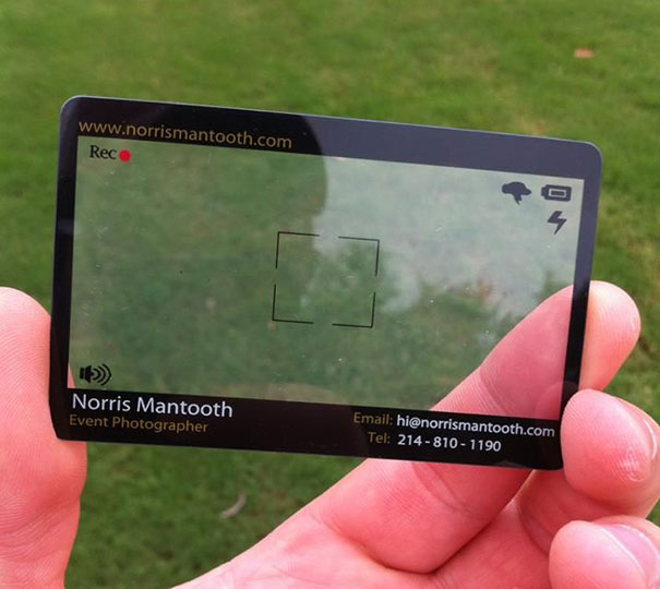 Transparent creative business card resembling a camera viewfinder held against a grassy background. Transparent creative business card resembling a camera viewfinder held against a grassy background.