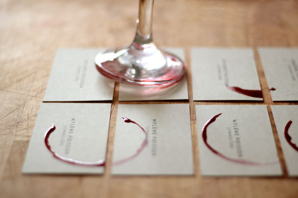 Creative business cards with wine glass stain designs on a wooden table. Creative business cards with wine glass stain designs on a wooden table.
