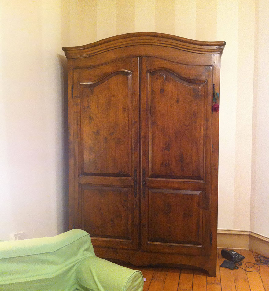 Wooden wardrobe in a creative kids room with vintage design and cozy green sofa for imaginative room ideas. Wooden wardrobe in a creative kids room with vintage design and cozy green sofa for imaginative room ideas.