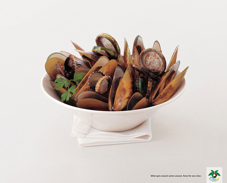 A bowl of mussels filled with bottle caps highlights a powerful advertisement on ocean pollution. A bowl of mussels filled with bottle caps highlights a powerful advertisement on ocean pollution.
