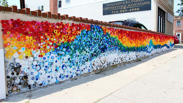 Colorful mural made from recycled plastic bottle caps on a street wall, showcasing creative recycling of old plastic bottles. Colorful mural made from recycled plastic bottle caps on a street wall, showcasing creative recycling of old plastic bottles.