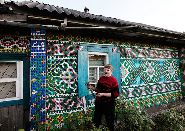 House exterior decorated with a mosaic of recycled plastic bottles in colorful patterns. House exterior decorated with a mosaic of recycled plastic bottles in colorful patterns.