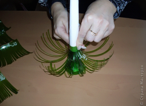 Hands crafting a decorative piece from an old plastic bottle, showcasing creative recycling techniques. Hands crafting a decorative piece from an old plastic bottle, showcasing creative recycling techniques.