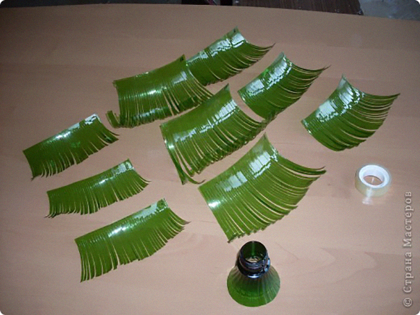 Recycled plastic bottles cut into green leaves, showcasing a creative DIY project. Recycled plastic bottles cut into green leaves, showcasing a creative DIY project.