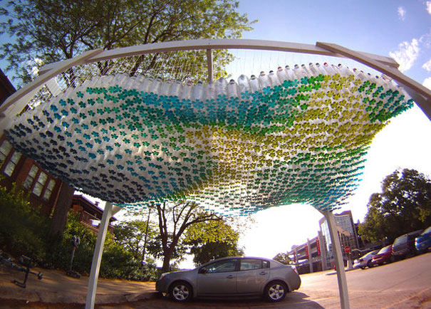 Creative recycled plastic bottle canopy providing shade in a parking area. Creative recycled plastic bottle canopy providing shade in a parking area.
