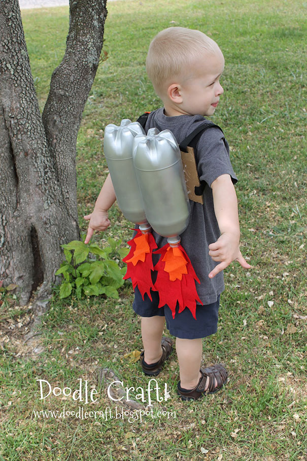 A child wearing a DIY jetpack made from recycled old plastic bottles in a grassy park area. A child wearing a DIY jetpack made from recycled old plastic bottles in a grassy park area.