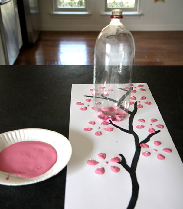 Painting cherry blossoms using a recycled plastic bottle and pink paint. Painting cherry blossoms using a recycled plastic bottle and pink paint.