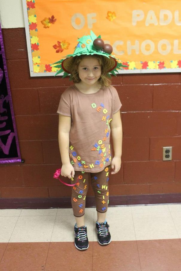 Young child wearing a creative Halloween costume with colorful letters, showcasing children's Halloween costume ideas.