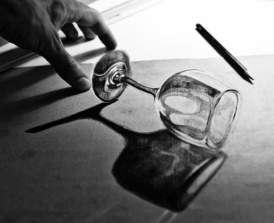 A hand reaching for a hyper-realistic 3D drawing of a wine glass with a pencil nearby. A hand reaching for a hyper-realistic 3D drawing of a wine glass with a pencil nearby.