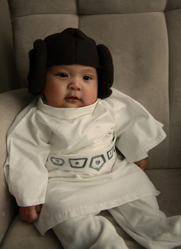 Baby dressed in a creative Halloween costume sitting on a chair, showcasing children's Halloween costume ideas.