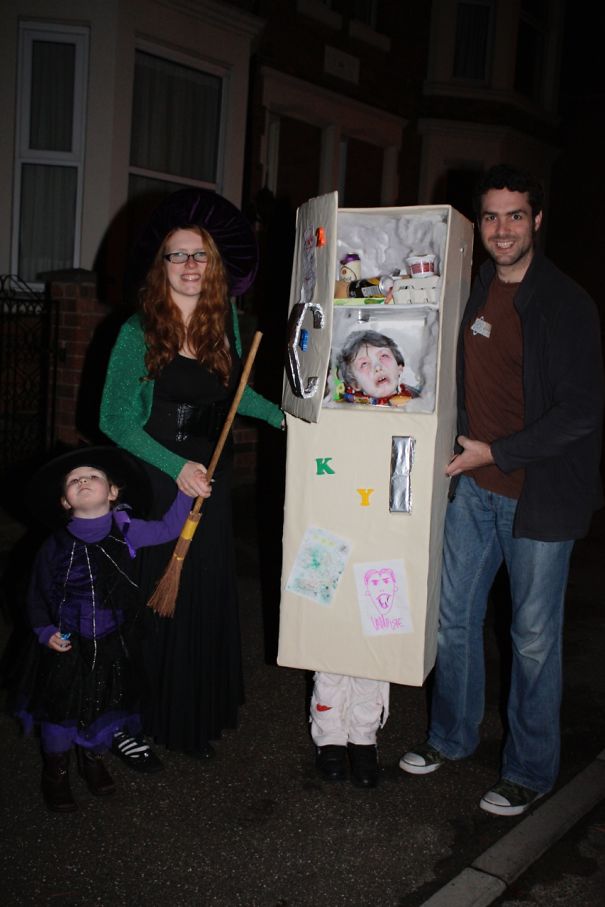 Family with children wearing creative Halloween costume ideas including a homemade fridge costume and witch outfits at night.