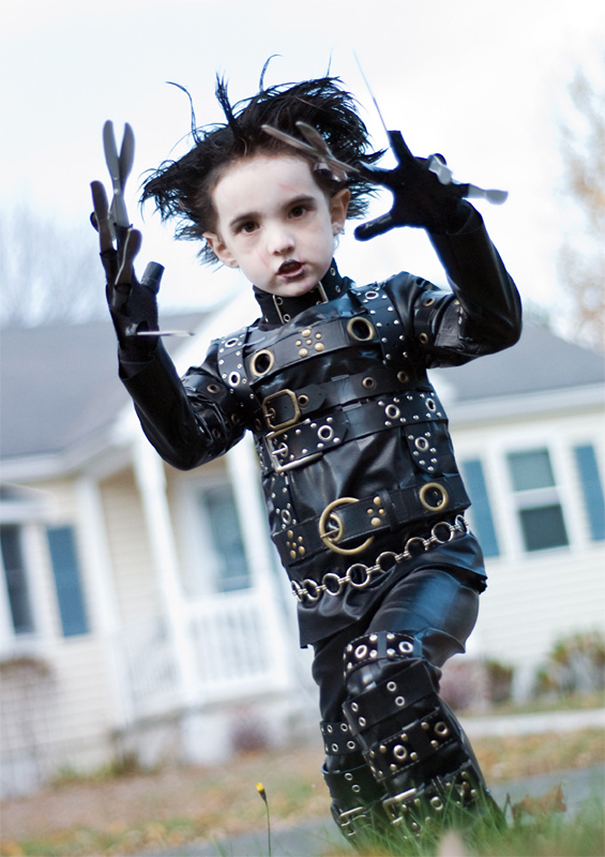Child dressed in a detailed Halloween costume with leather straps and blades, showcasing children's Halloween costume ideas outdoors.