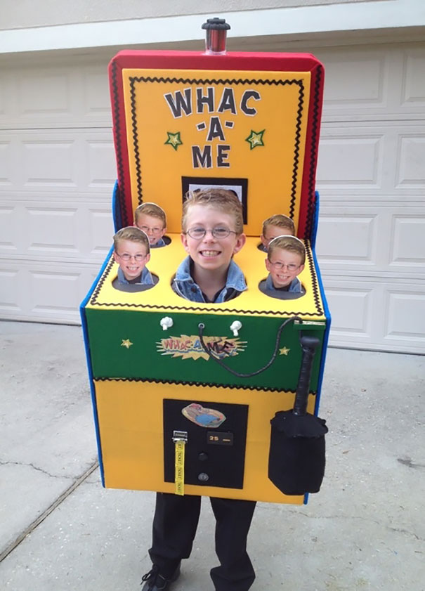 Child wearing a creative Whac-A-Mole Halloween costume with multiple faces for children's Halloween costume ideas.