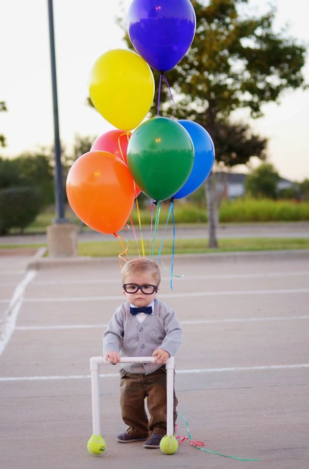 Toddler dressed in a creative costume with balloons, illustrating fun children's Halloween costume ideas outdoors.