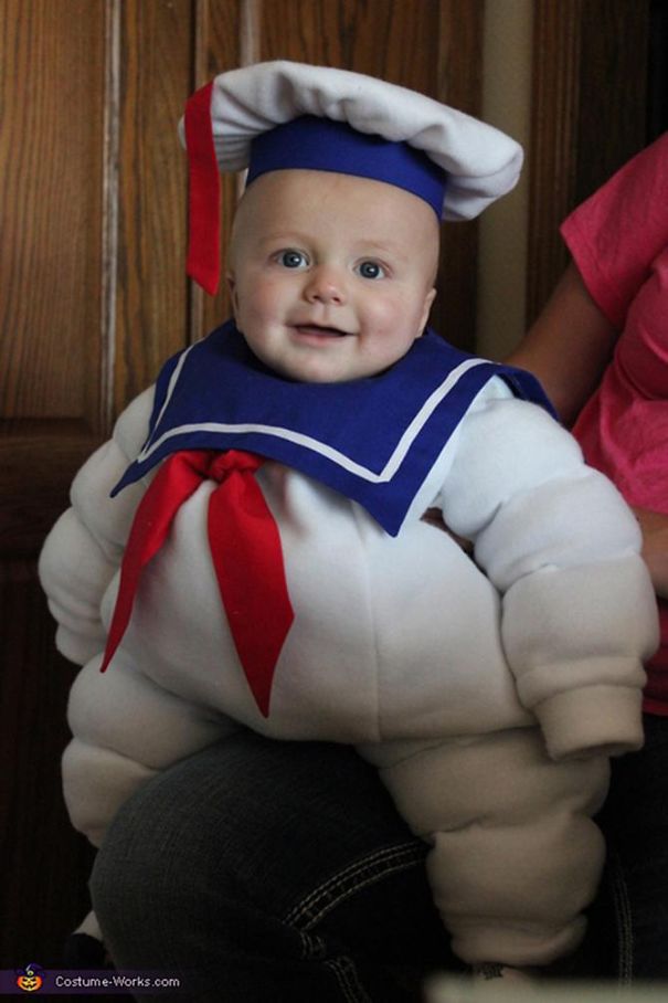 Baby in an inflatable Halloween costume sitting on an adult's lap showing children's Halloween costume ideas.
