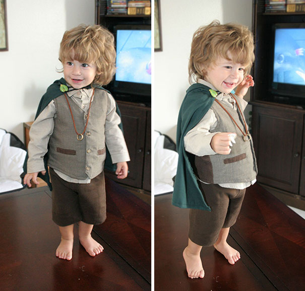 Toddler dressed in a creative children's Halloween costume idea with a green cape and vintage-style outfit indoors.