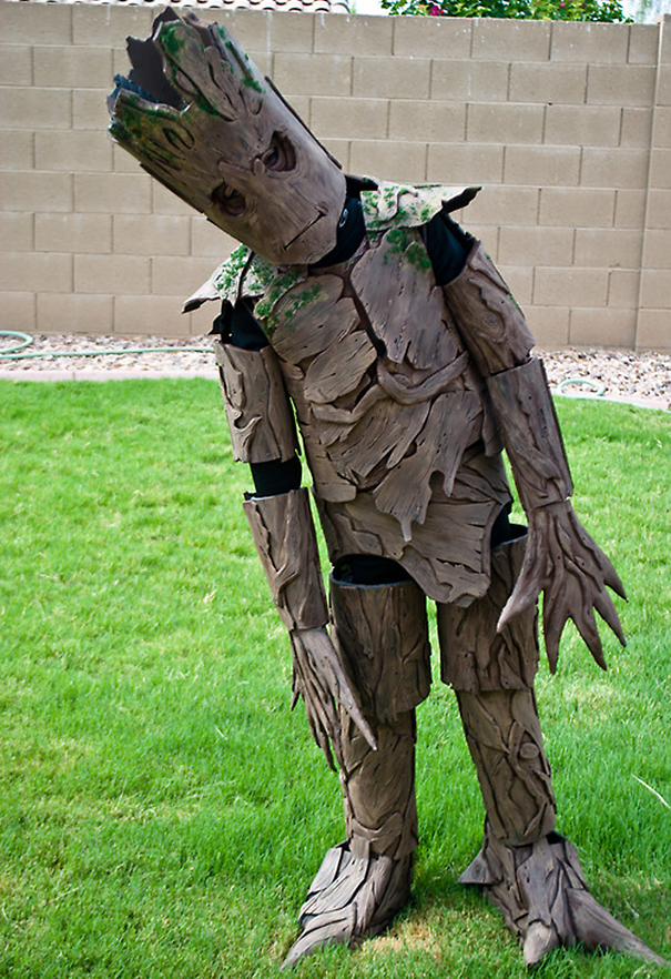 Child wearing a detailed tree or Groot-inspired costume standing on grass for children's Halloween costume ideas.