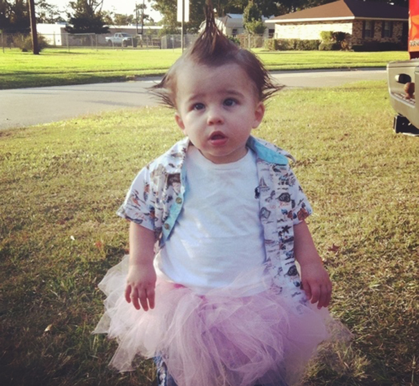 Toddler with a mohawk wearing a pink tutu and patterned shirt outdoors, showcasing creative children's Halloween costume ideas.