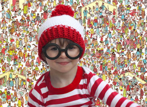 Child dressed in a Halloween costume with large glasses and a red and white hat among crowds, children's Halloween costume ideas.