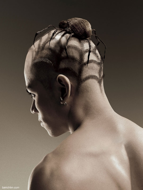 A man with a crazy haircut styled to resemble a large spider sitting atop his head.