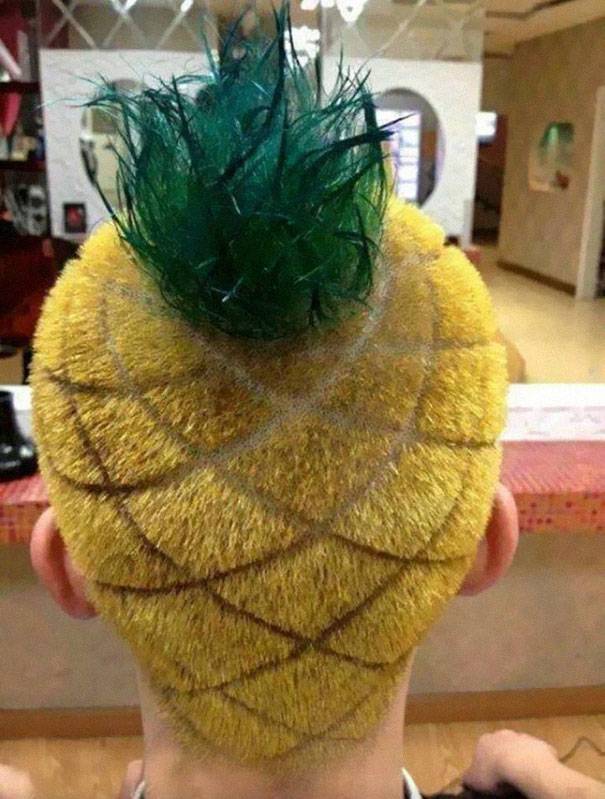 A hairstyle resembling a pineapple with yellow sides and a green tuft on top, showcasing a crazy haircut design.