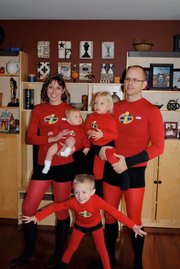 Family of five dressed in matching superhero outfits for children's Halloween costume ideas at home.