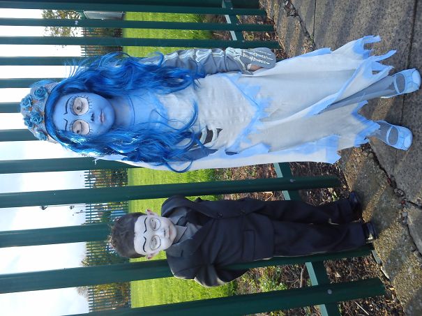 Two children in detailed Halloween costumes with face paint, showcasing creative children's Halloween costume ideas outdoors.
