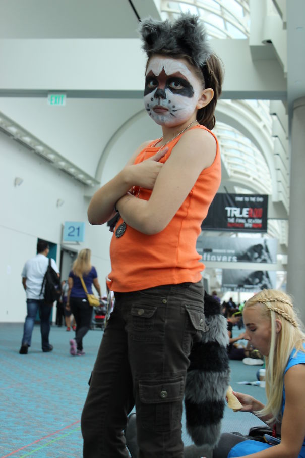 Child dressed in a Halloween costume with face paint and a furry headband, showcasing children's Halloween costume ideas.