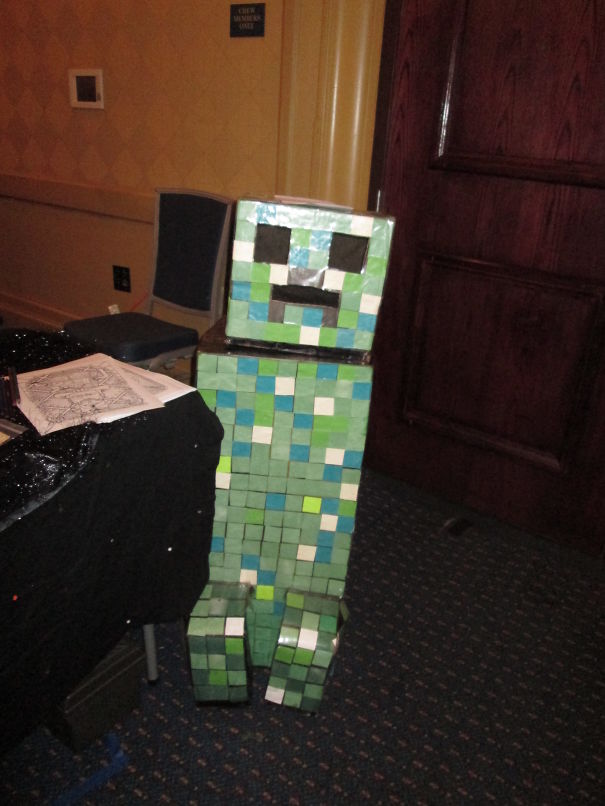 Child wearing a pixelated green and blue costume inspired by a Minecraft character for children's Halloween costume ideas.