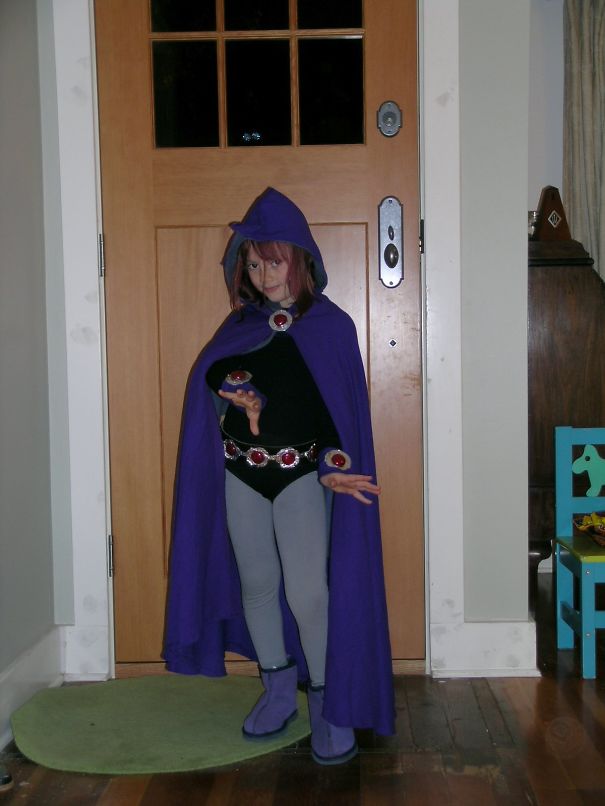 Child wearing a purple magical cloak and costume posing indoors for children’s Halloween costume ideas.