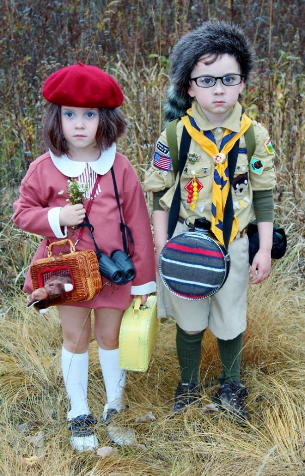 Two children dressed in creative Halloween costume ideas standing outdoors in fall grass.