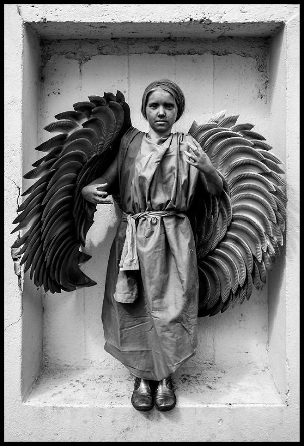 Child dressed with large wings and a robe, showcasing unique children's Halloween costume ideas in a creative setting.