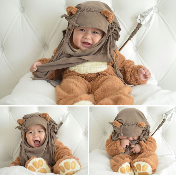 Baby dressed in an adorable brown animal costume for children's Halloween costume ideas sitting on a white cushioned chair.