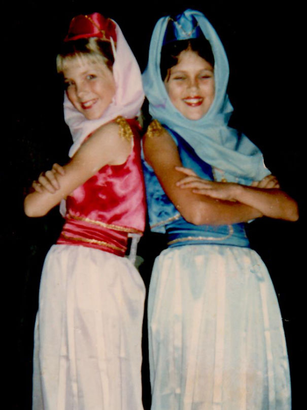 Two children wearing colorful Halloween costumes posing back to back for children's Halloween costume ideas.