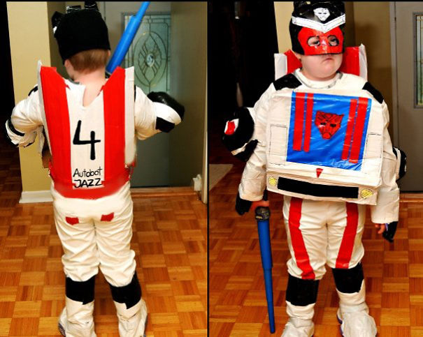Child dressed in a DIY robot costume holding a blue bat, showcasing creative children's Halloween costume ideas indoors.