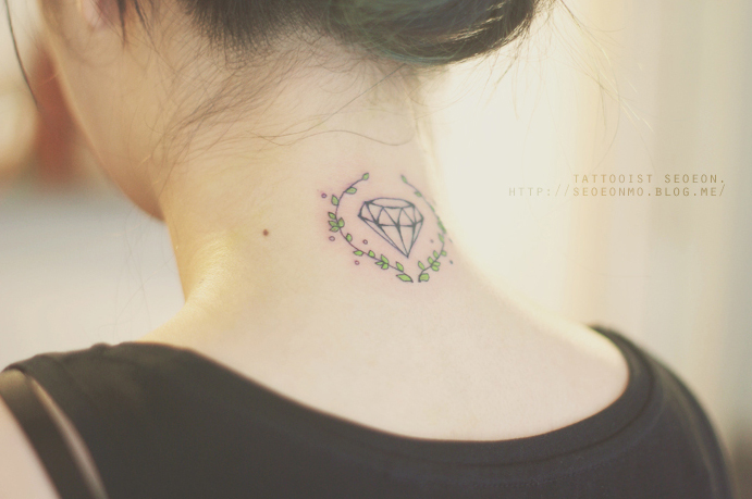 A minimalistic tattoo by Seoeon featuring a discreet diamond with floral accents on a woman's neck. A minimalistic tattoo by Seoeon featuring a discreet diamond with floral accents on a woman's neck.