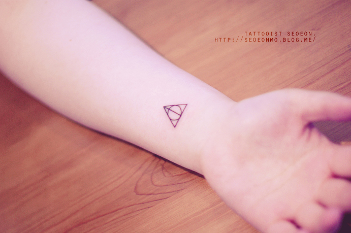 Minimalistic tattoo on wrist by Seoeon, featuring a geometric design. Minimalistic tattoo on wrist by Seoeon, featuring a geometric design.