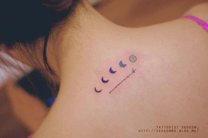 Minimalistic tattoo by Seoeon featuring moon phases on a woman's upper back. Minimalistic tattoo by Seoeon featuring moon phases on a woman's upper back.