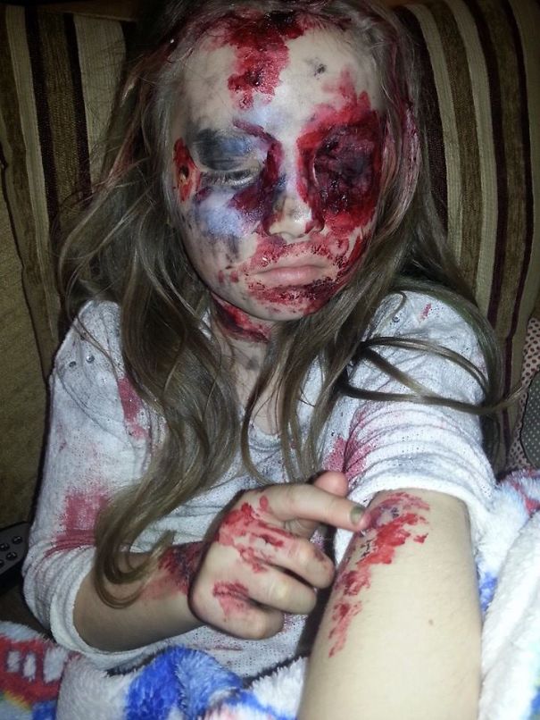 Child dressed in a scary Halloween costume with fake blood and face paint showing a zombie or horror look for kids.