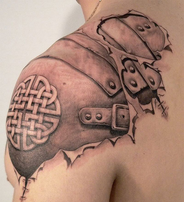 3D tattoo of armor on shoulder with intricate knot design, creating a mind-twisting illusion.