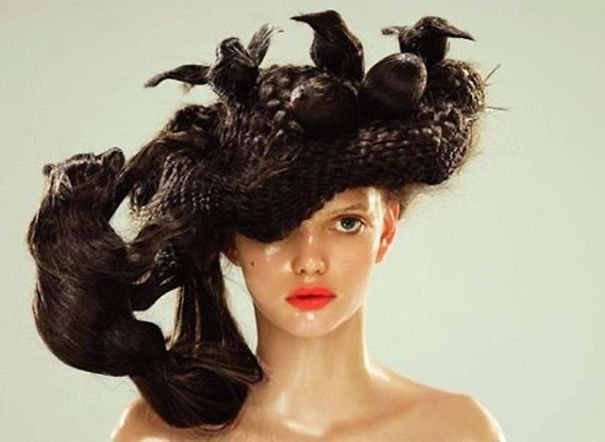 Woman with an elaborate, crazy haircut styled into intricate shapes resembling birds.