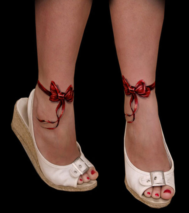 3D tattoo of realistic red ribbons around ankles, creating a mind-twisting optical illusion.