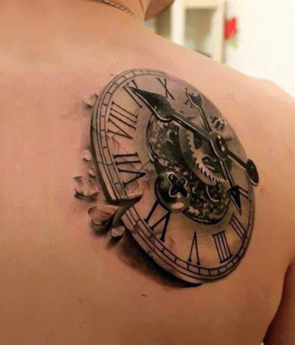 3D tattoo of a clock with Roman numerals on a person's shoulder, creating a mind-twisting illusion.