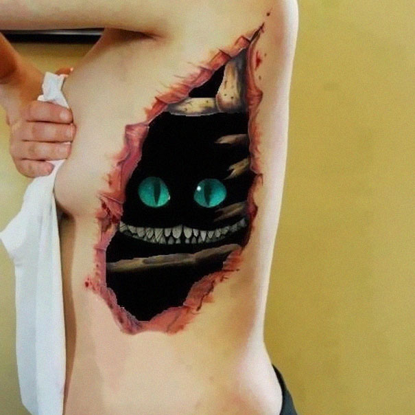 3D tattoo of a grinning face with glowing eyes, creating an illusion on skin.
